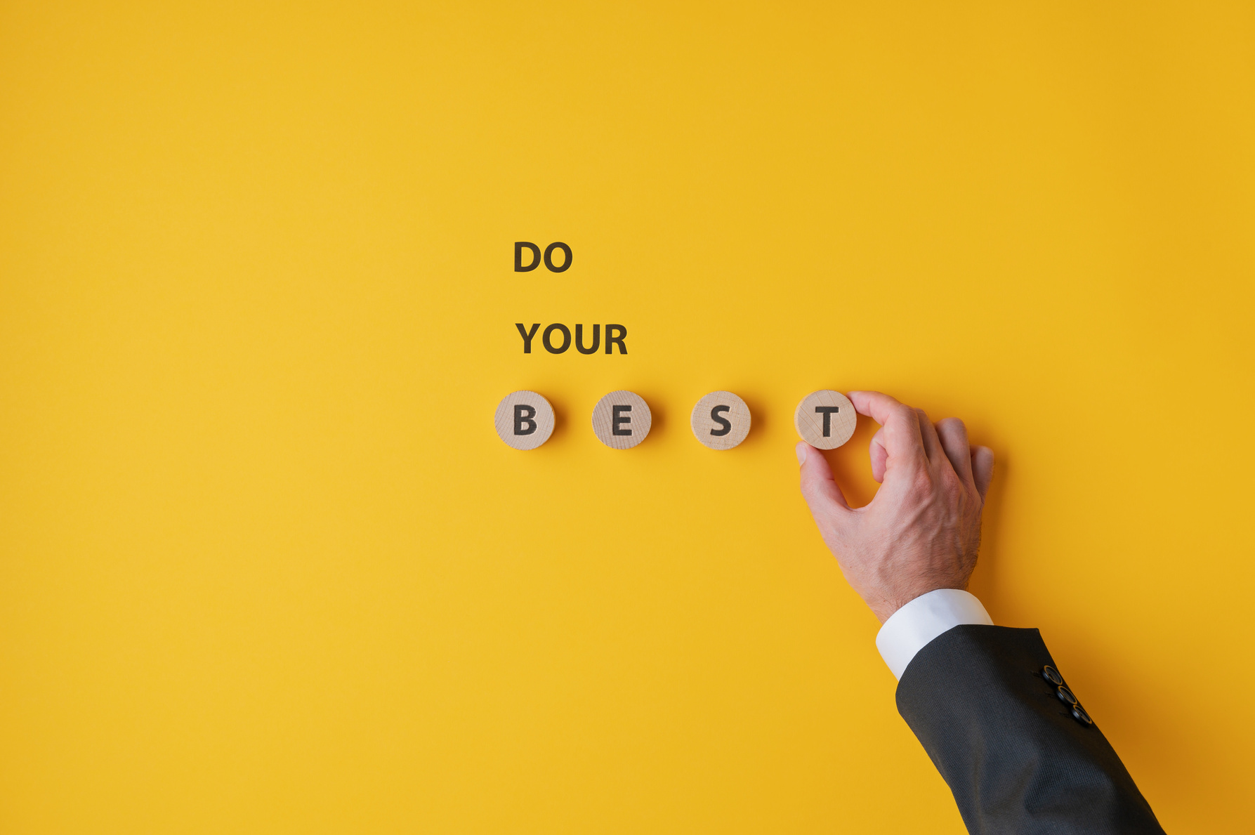 Hand of a Businessman Making a Do Your Best Sign